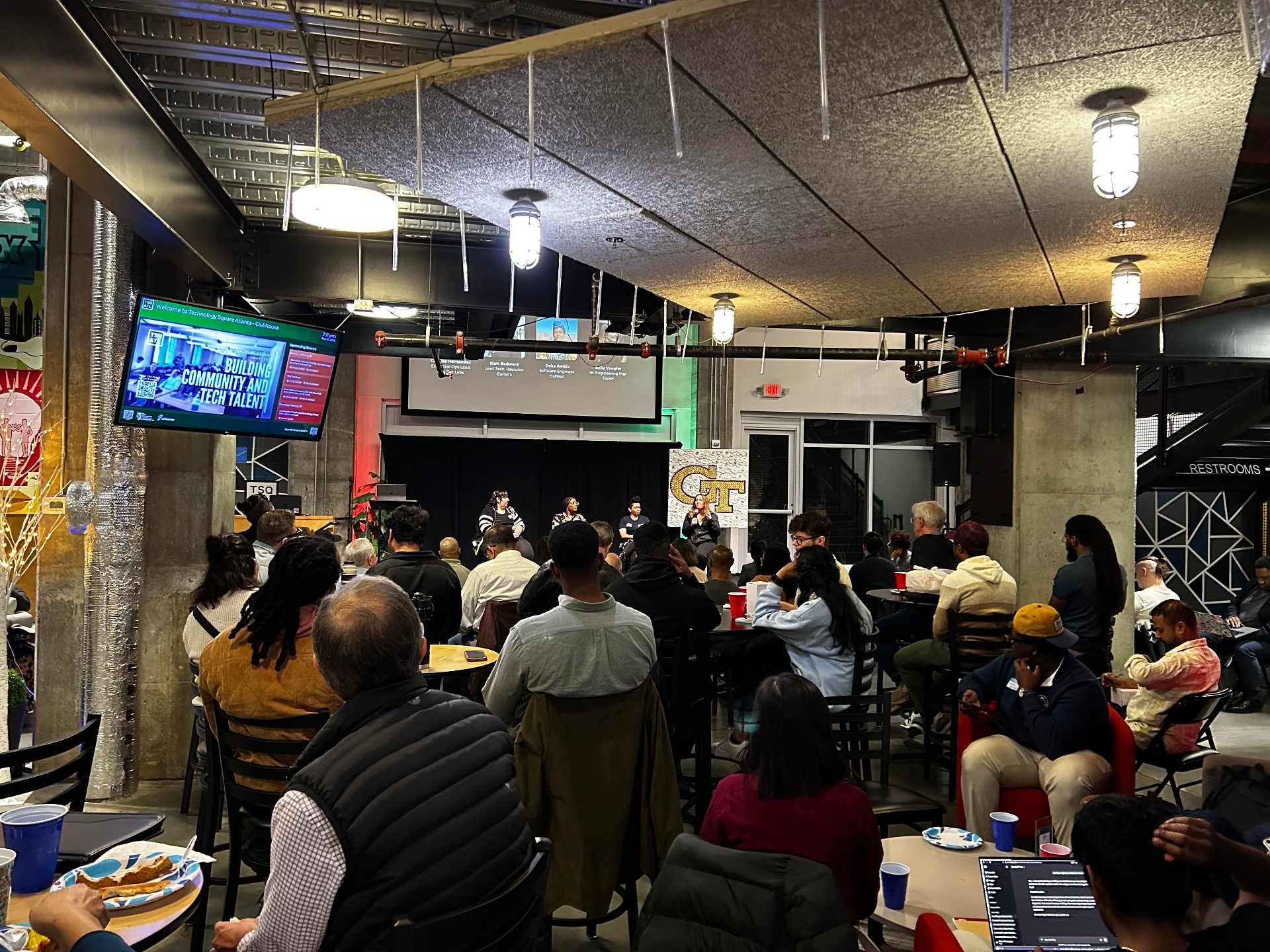 Panelists on stage at a REFACTR event